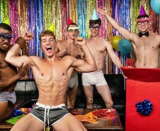 Felix Fox's buddies have got him a special surprise for his birthday bash: Michael Boston, who jumps out of a wrapped present wearing nothing but a pair of tight briefs and a bowtie to give Felix a lap dance.